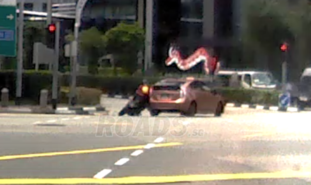 Accident between motorcycle and taxi when both making left turn at junction